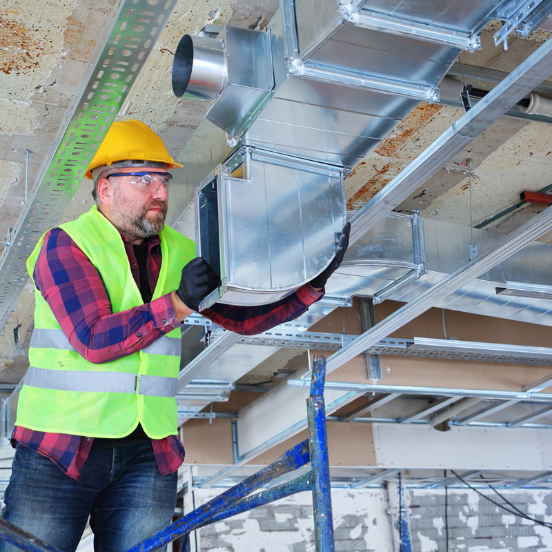 handyman working on duct work