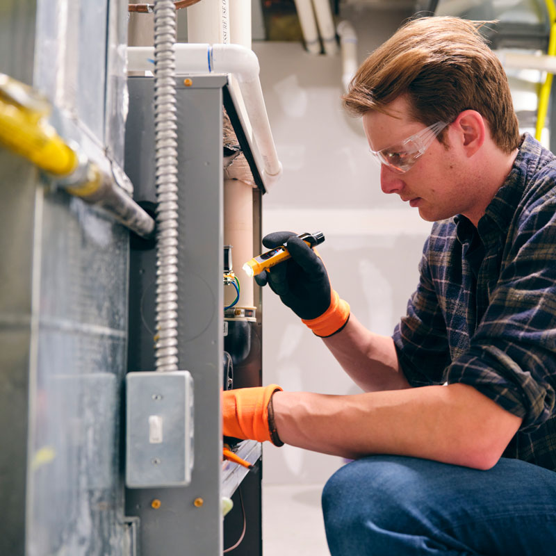 handyman repairing furnace